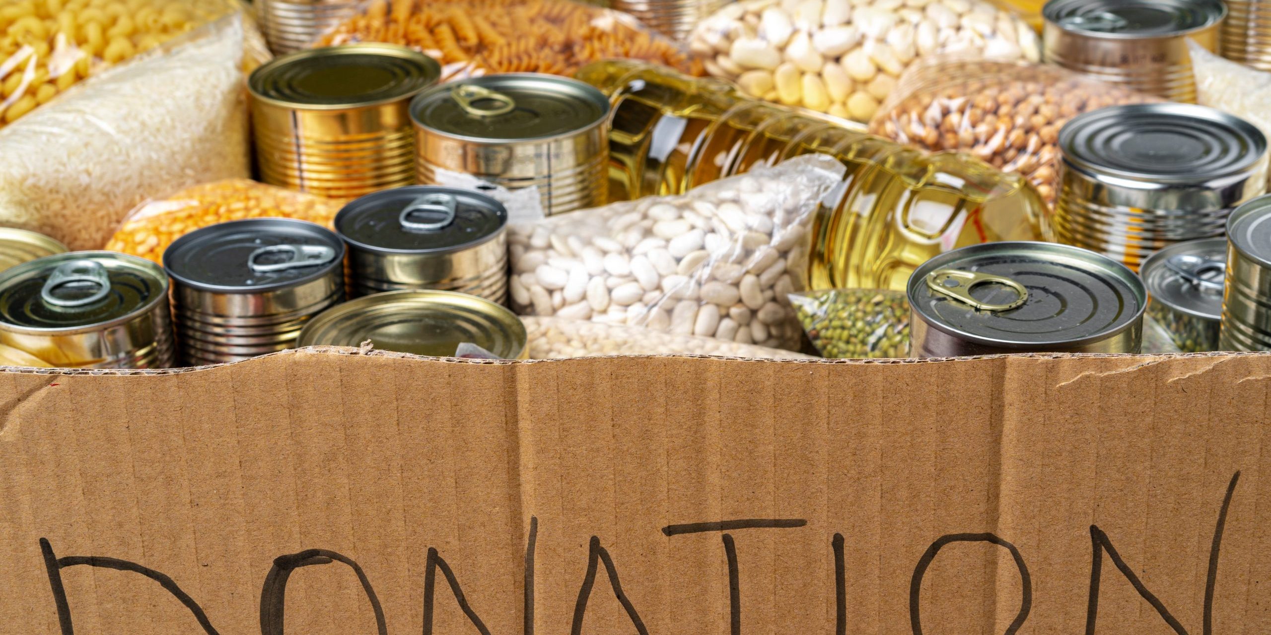Food donations on the table. Text Donation.
